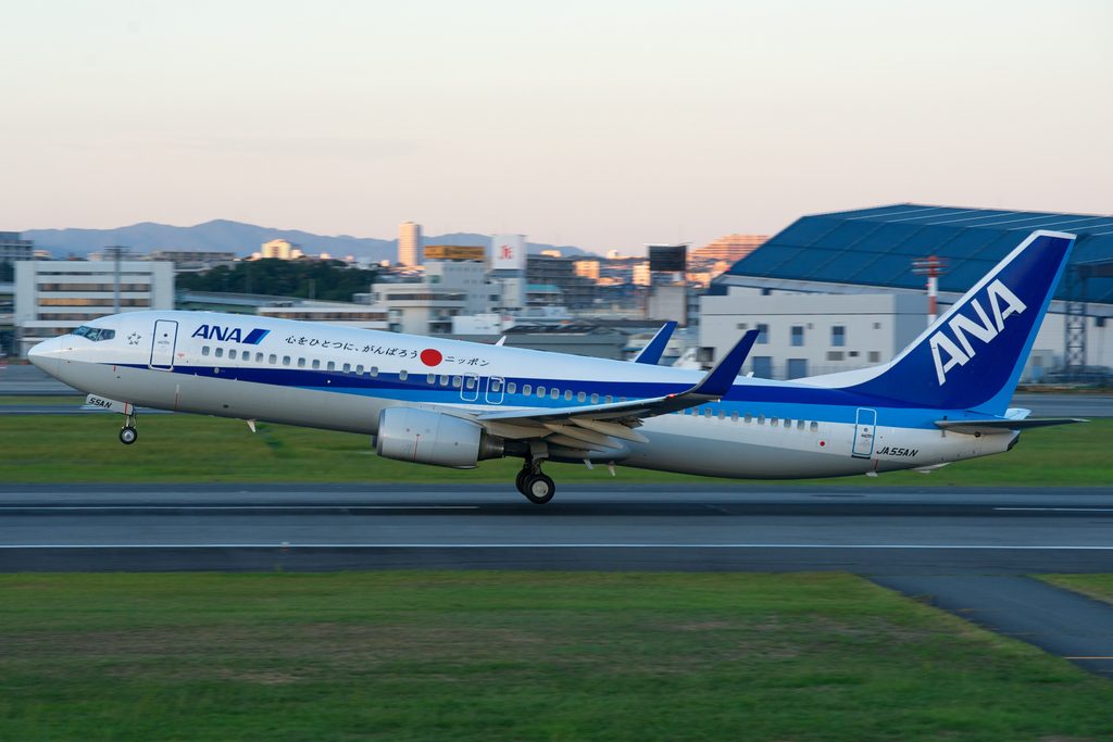 An ANA Boeing 737-800 returned to Okinawa after an engine shutdown at FL220. Passengers evacuated via slides and three suffered minor injuries.