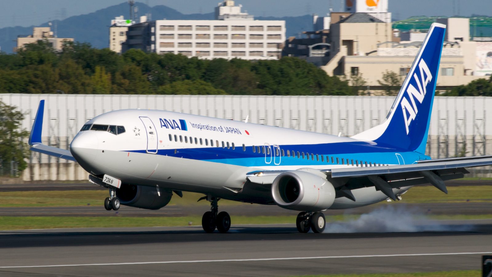 An ANA Boeing 737-800 returned to Okinawa after an engine shutdown at FL220. Passengers evacuated via slides and three suffered minor injuries.