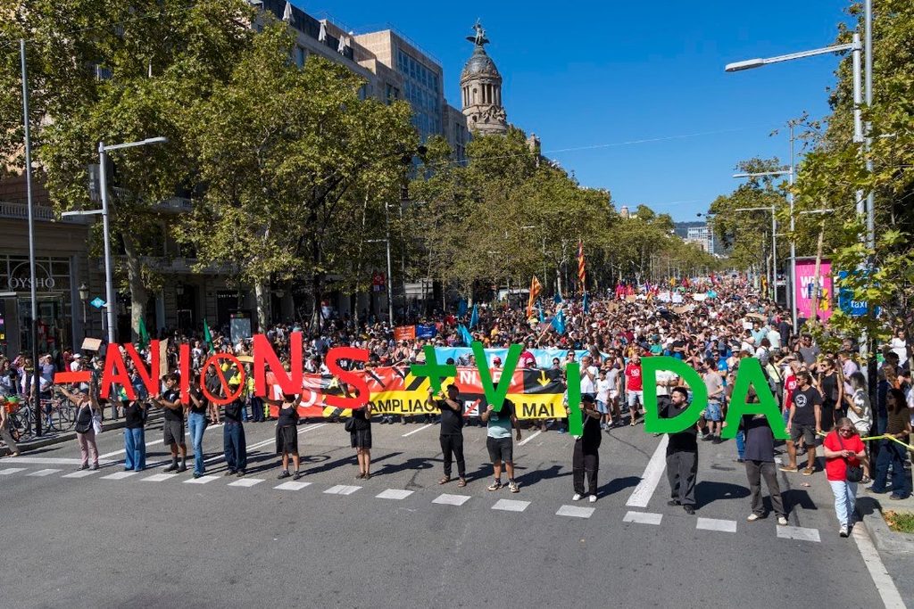 Protesters march through Barcelona against the El Prat airport expansion.