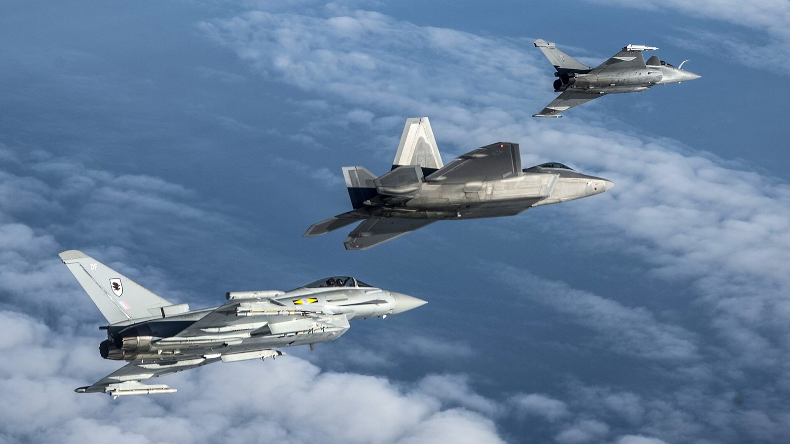 RAF Typhoons: A British Royal Air Force Typhoon, U.S. Air Force F-22 Raptor and French air force Rafale fly in formation as